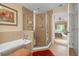 Bathroom with walk-in shower and view into bedroom at 7650 Whisper Way # 203, Reunion, FL 34747