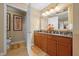 Bathroom with double vanity and toilet at 7650 Whisper Way # 203, Reunion, FL 34747