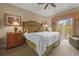 Luxurious main bedroom with king bed and private balcony access at 7650 Whisper Way # 203, Reunion, FL 34747