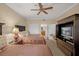 Guest bedroom with two double beds, ceiling fan, and built-in entertainment center at 7650 Whisper Way # 203, Reunion, FL 34747