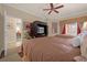 Bedroom with two double beds, ceiling fan, and access to a private balcony at 7650 Whisper Way # 203, Reunion, FL 34747