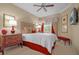 Bright bedroom featuring a queen bed, decorative accents, and large windows with window treatments at 7650 Whisper Way # 203, Reunion, FL 34747