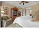 Main bedroom with king-size bed and sitting area at 7650 Whisper Way # 203, Reunion, FL 34747