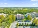 Aerial view showcasing the community's location, landscaping, and building exterior at 7650 Whisper Way # 203, Reunion, FL 34747