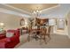 Charming dining area with a round table and chairs, adjacent to the kitchen at 7650 Whisper Way # 203, Reunion, FL 34747