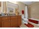 Bathroom with tiled shower/tub combo, vanity with granite countertop, and updated fixtures at 7650 Whisper Way # 203, Reunion, FL 34747