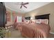 Guest bedroom with two double beds, ceiling fan, and neutral decor at 7650 Whisper Way # 203, Reunion, FL 34747