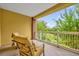 Relaxing balcony with two chairs and tranquil view at 7650 Whisper Way # 203, Reunion, FL 34747