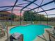 Stunning pool area with a screened enclosure and beautiful sunset at 270 Earlmont Pl, Davenport, FL 33896
