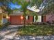 Charming single-story home with a peach-colored exterior and two-car garage at 270 Earlmont Pl, Davenport, FL 33896