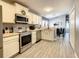 Bright kitchen featuring stainless steel appliances and white cabinets at 270 Earlmont Pl, Davenport, FL 33896