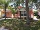 Charming light pink house with a two-car garage and well-manicured lawn at 270 Earlmont Pl, Davenport, FL 33896