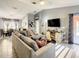 Spacious living room with sectional sofa, large TV, and adjacent dining area at 270 Earlmont Pl, Davenport, FL 33896