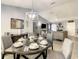 Modern dining room with round table and chairs, offering a view of the living room at 270 Earlmont Pl, Davenport, FL 33896