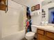 Bathroom with tub, mario theme shower curtain, and wood cabinets at 270 Earlmont Pl, Davenport, FL 33896