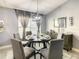 Well-lit dining area with round table and chairs, adjacent to a window at 270 Earlmont Pl, Davenport, FL 33896