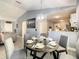Elegant dining room with round table and six chairs, open to the living room and kitchen at 270 Earlmont Pl, Davenport, FL 33896
