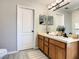 Bathroom with double vanity, a large mirror and wood cabinets at 270 Earlmont Pl, Davenport, FL 33896