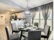 Round dining table with six chairs, situated near the kitchen and living room at 270 Earlmont Pl, Davenport, FL 33896