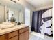 Bathroom with double vanity, shower, and modern finishes at 270 Earlmont Pl, Davenport, FL 33896