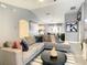 Open-concept living room with sectional sofa and a view into the dining area and kitchen at 270 Earlmont Pl, Davenport, FL 33896