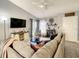 Bright living room featuring a sectional sofa, flat-screen TV and access to patio at 270 Earlmont Pl, Davenport, FL 33896