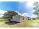 Tan metal workshop building with roll-up door at 4121 Albritton Rd, St Cloud, FL 34772