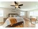 Main bedroom with a king-size bed, sitting area, and ceiling fan at 4121 Albritton Rd, St Cloud, FL 34772