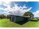 Green two-car garage with dark roll-up doors at 4121 Albritton Rd, St Cloud, FL 34772