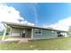 Green house exterior with covered patio and grassy yard at 4121 Albritton Rd, St Cloud, FL 34772