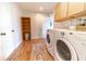 Laundry room with washer, dryer, and built-in shelving at 4121 Albritton Rd, St Cloud, FL 34772