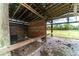 Wooden barn interior with open sides and brick flooring at 4121 Albritton Rd, St Cloud, FL 34772