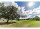 Spacious backyard with large tree and home in background at 4121 Albritton Rd, St Cloud, FL 34772