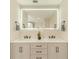 Elegant bathroom featuring a double vanity with modern fixtures and an illuminated mirror at 4121 Albritton Rd, St Cloud, FL 34772