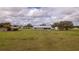 View of home from backyard, showing large grassy area at 4121 Albritton Rd, St Cloud, FL 34772