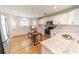 Well-lit kitchen with white cabinets, marble countertops, and a large sink at 4121 Albritton Rd, St Cloud, FL 34772