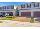 Two-story townhome with a two-car garage and landscaped yard at 4919 Conifer Cone Dr, Kissimmee, FL 34746