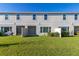 Private backyard with grassy area, patio, and townhome at 4919 Conifer Cone Dr, Kissimmee, FL 34746