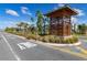 Community entrance with signage and landscaping at 4919 Conifer Cone Dr, Kissimmee, FL 34746