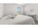 Bedroom with a bed, desk, and window with blinds at 4919 Conifer Cone Dr, Kissimmee, FL 34746