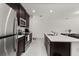 Modern kitchen with island, stainless steel appliances, and dark wood cabinets at 4919 Conifer Cone Dr, Kissimmee, FL 34746