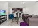 Open living area with kitchen, seating, and a large TV at 4919 Conifer Cone Dr, Kissimmee, FL 34746