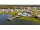 Community pool and lakefront amenity area with surrounding homes at 4919 Conifer Cone Dr, Kissimmee, FL 34746