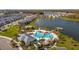 Community pool and lakefront amenity area with surrounding homes at 4919 Conifer Cone Dr, Kissimmee, FL 34746