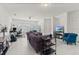 Open living area with seating, workspace, and backyard access at 4919 Conifer Cone Dr, Kissimmee, FL 34746