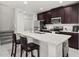 Modern kitchen with island, stainless steel appliances, and dark wood cabinets at 4919 Conifer Cone Dr, Kissimmee, FL 34746