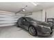 Garage with one car and storage shelves at 4919 Conifer Cone Dr, Kissimmee, FL 34746