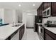 Modern kitchen with island, stainless steel appliances, and dark wood cabinets at 4919 Conifer Cone Dr, Kissimmee, FL 34746