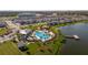 Community pool and lakefront amenity area with surrounding homes at 4919 Conifer Cone Dr, Kissimmee, FL 34746