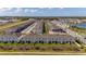 Aerial view of townhouses with lake and road at 4919 Conifer Cone Dr, Kissimmee, FL 34746